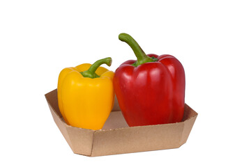 Two bell peppers, red and yellow, in a cardboard box.
