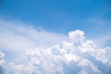 Blue sky with clouds as background. Cloud is aerosol comprising visible mass liquid. Relaxation and comfortable concept. Natural light and fluffy