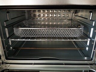 Empty oven with basket for grilling, baking