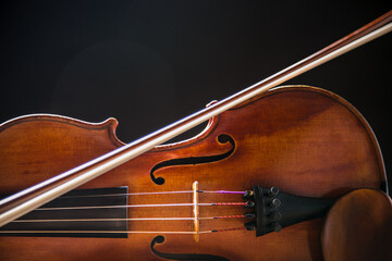 Close up of a violin isolated on a black background