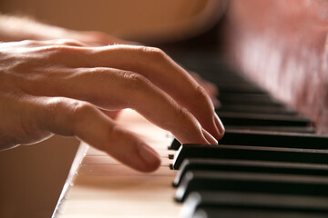 Obraz premium Close-up of hands playing the piano