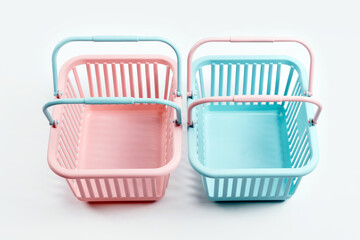 Colorful plastic shopping baskets. Empty pink and blue supermarket baskets on grey background....