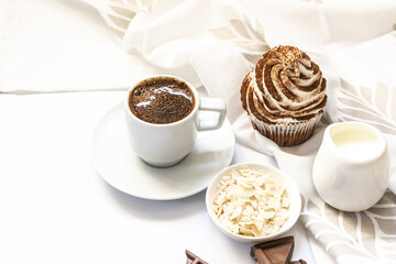 Dark chocolate and cocoa chocolate cupcakes with a cup of hot black coffee