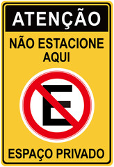 No parking sign in portuguese language that says : ATTENTION NO PARKING HERE. PRIVATE SPACE.