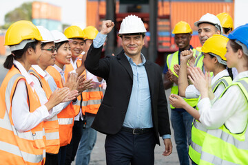 warehouse boss engineer with factory workers raise hand and clapping hands together for...