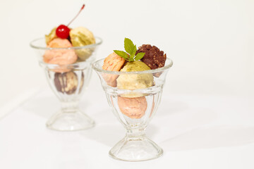 Close up of ice-cream in glass cup on white
