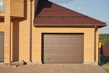 Garage with automatic garage door attached to the house.