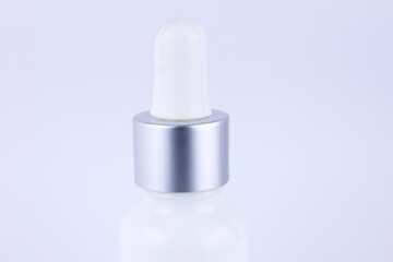 cosmetic bottle close-up with gray stopper