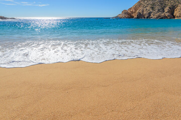 Santa Maria Beach, Cabo San Lucas, Mexico. Different stages of the fantastic ocean waves. Rocky and sandy beach.