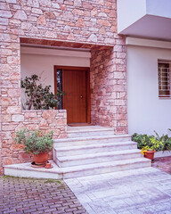 Fototapeta na wymiar elegant house front marble stairs and natural wood door, Athens Greece