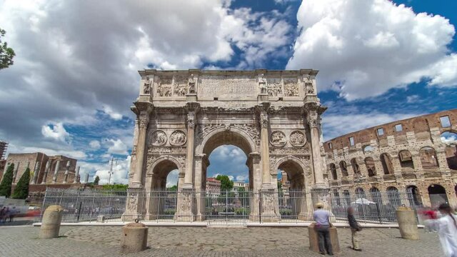 Arch of Constantine timelapse hyperlapse, Rome, Italy. Built to commemorate the emperor's victory over his rival Maxentius in AD 312. Located near colosseum. Blue cloudy sky and crowd around