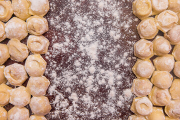 Dumplings homemade food in flour, cooked at home, culinary unckooked composition, copy space