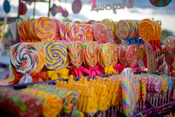 Fototapeta na wymiar Multicolored sweet candies and lollipops at the holiday market