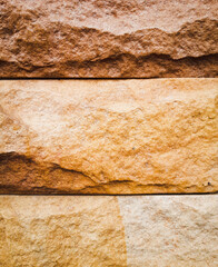 old background Stone texture brick wall Brown color, close up view of the rock surface and details sandstone wall concept of wallpaper background or backdrop.