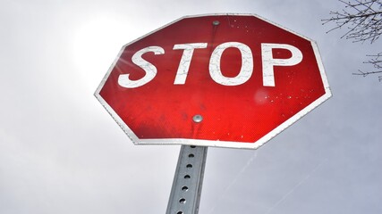 stop sign from an upward angle looking toward the sky