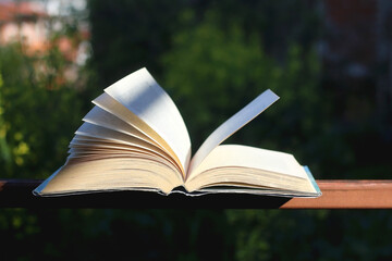 Open book in a garden. Selective focus.