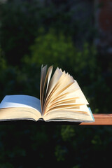 Open book in a garden. Selective focus.
