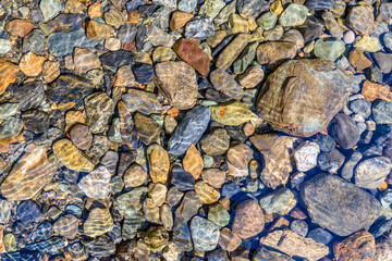 Pebbles under water background. Magnificent Seton Lake in Canada.