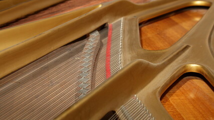 Classic Grand Piano inside view with strings and pegs under opened cover , musical instruments...