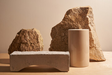 Beige stone and a piece of gray podium tile on a beige background, natural background for your...
