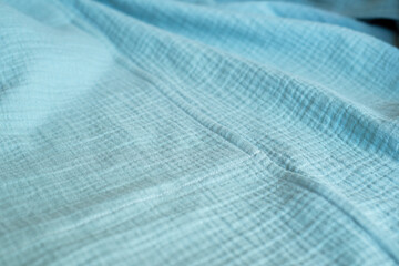 Turquoise muslin fabric. Natural organic cotton textiles.