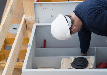 assembly of industrial equipment by worker