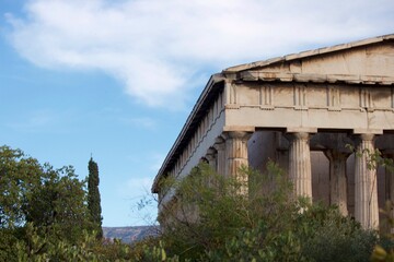 Fototapeta na wymiar Old Greek Temple overgrown with trees