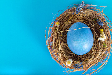 Colorful background with Easter eggs on blue background. Happy Easter concept. Can be used as poster, background, holiday card. Flat lay, top view, copy space. Studio Photo