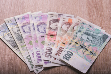 Close up on Czech money laying on the table. Different value of the Czech crown. Lots of money, lots of banknotes.