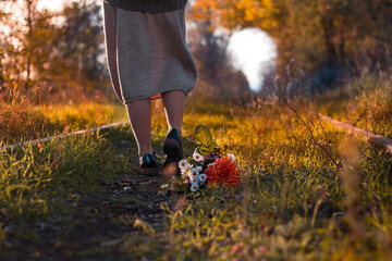 Girl with flowers in autumn on railway