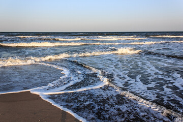 Intersecting waves on a sandy seashore