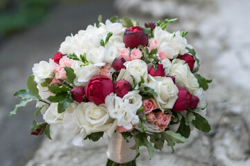 Beautiful bridal bouquet of red roses and white freesia.
