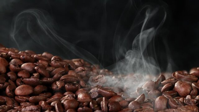 Super slow motion of roasting coffee beans with smoke. Filmed on high speed cinema camera.