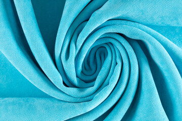 curtain fabric canvas bright turquoise, rolled into a spiral