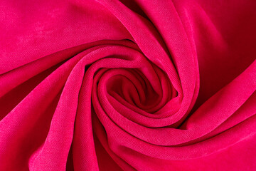 curtain fabric canvas bright pink, rolled into a spiral