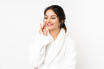 Young caucasian woman isolated on white background with cotton pad for removing makeup from her face