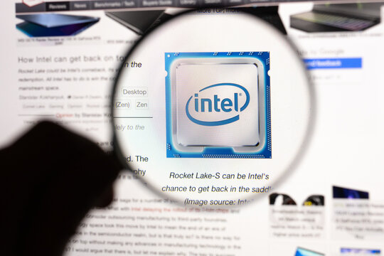 Intel logo on the internet seen on a computer screen through a magnifying glass