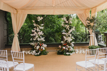 Coziness and style. Modern event design. Lounge zone and european traditional wedding ceremony decoration outdoors in the restaurant before the reception.
