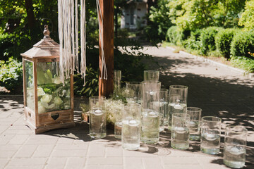 Coziness and style. Modern event design. Lounge zone and european traditional wedding ceremony decoration outdoors in the restaurant before the reception.