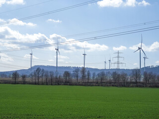 Fototapeta na wymiar Windmill against blue sky in sunshine