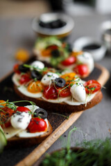 Toast with cherry tomatoes, mozzarella and microgreens. Light healthy breakfast. View from above.