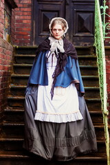 Obraz premium Young woman in vintage dress late 19th century 