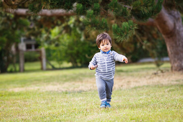 Little eastern handsome baby boy playing outdoor in the park