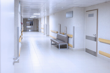 Light hospital corridor with white doors closeup