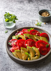 avocado and tomato salad with pine nuts