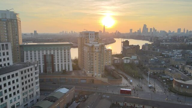 Aerial view of Europe famous Eixample residencial district with river and sun reflection urban grid, at sunset