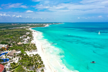 Drone photo of a white sand beach and clear blue water in Cancun, Mexico
