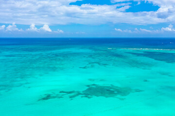 Drone photo of a white sand beach and clear blue water in Cancun, Mexico