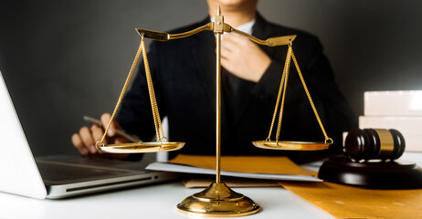justice and law concept.Male judge in a courtroom on wooden table and Counselor or Male lawyer...