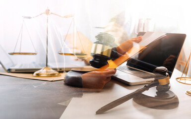 Business and lawyers discussing contract papers with brass scale on desk in office. Law, legal services, advice, justice and law concept picture with film grain effect